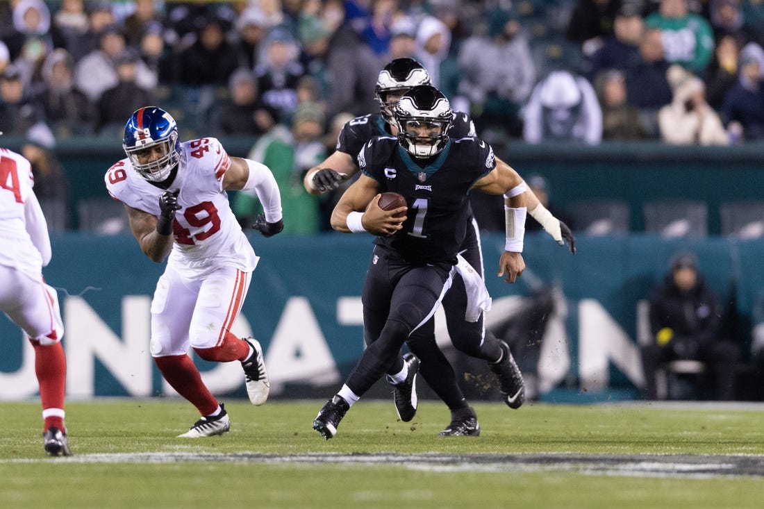 Jan 8, 2023; Philadelphia, Pennsylvania, USA; Philadelphia Eagles quarterback Jalen Hurts (1) runs with the ball in front of New York Giants linebacker Tomon Fox (49) during the third quarter at Lincoln Financial Field. Mandatory Credit: Bill Streicher-USA TODAY Sports