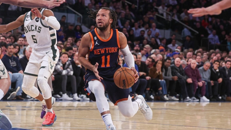Jan 9, 2023; New York, New York, USA; New York Knicks guard Jalen Brunson (11) drives to the basket in front of Milwaukee Bucks guard Jevon Carter (5) during the first half at Madison Square Garden. Mandatory Credit: Vincent Carchietta-USA TODAY Sports