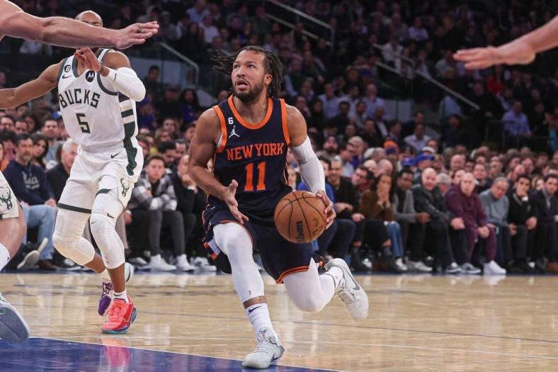 Jan 9, 2023; New York, New York, USA; New York Knicks guard Jalen Brunson (11) drives to the basket in front of Milwaukee Bucks guard Jevon Carter (5) during the first half at Madison Square Garden. Mandatory Credit: Vincent Carchietta-USA TODAY Sports