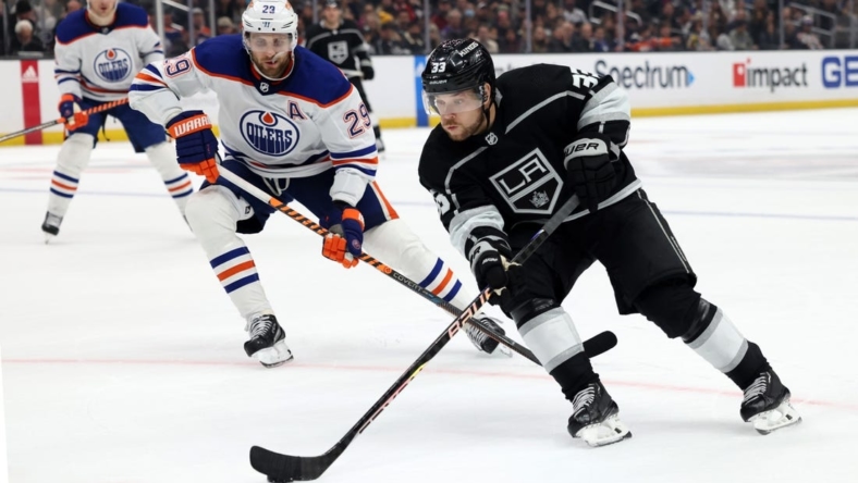 Jan 9, 2023; Los Angeles, California, USA; Los Angeles Kings right wing Viktor Arvidsson (33) controls the puck in front of Edmonton Oilers center Leon Draisaitl (29) during the second period against the Edmonton Oilers at Crypto.com Arena. Mandatory Credit: Jason Parkhurst-USA TODAY Sports