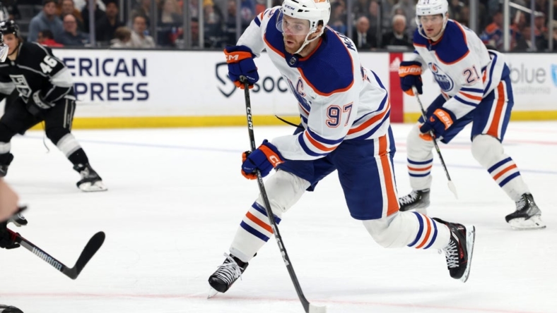 Jan 9, 2023; Los Angeles, California, USA; Edmonton Oilers center Connor McDavid (97) shoots and scores during the third period against the Los Angeles Kings at Crypto.com Arena. Mandatory Credit: Jason Parkhurst-USA TODAY Sports