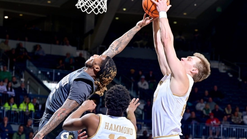 Jan 10, 2023; South Bend, Indiana, USA; Georgia Tech Yellow Jackets guard Deivon Smith (5) and Notre Dame Fighting Irish guard Dane Goodwin (23) reach for a rebound in the first half at the Purcell Pavilion. Mandatory Credit: Matt Cashore-USA TODAY Sports