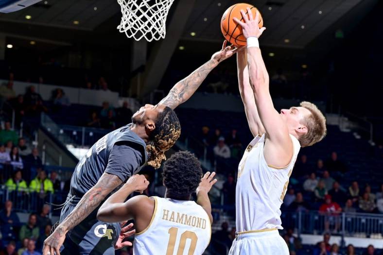Jan 10, 2023; South Bend, Indiana, USA; Georgia Tech Yellow Jackets guard Deivon Smith (5) and Notre Dame Fighting Irish guard Dane Goodwin (23) reach for a rebound in the first half at the Purcell Pavilion. Mandatory Credit: Matt Cashore-USA TODAY Sports
