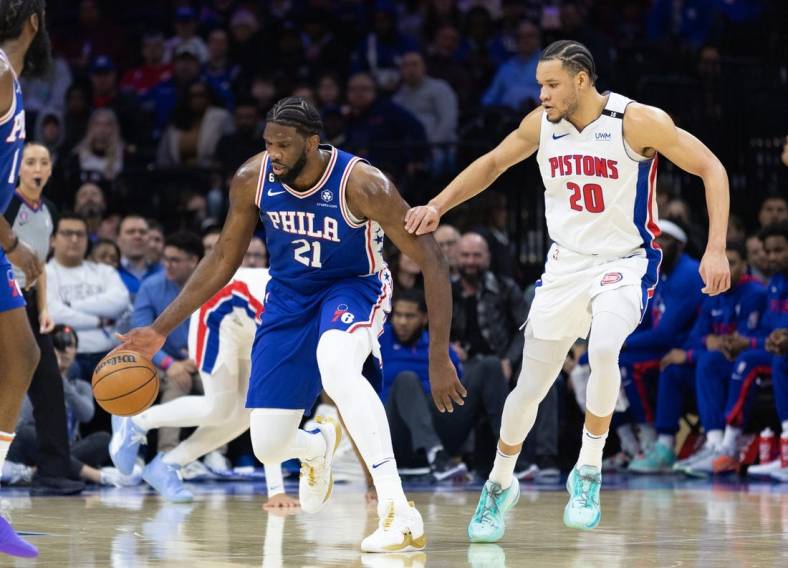 Jan 10, 2023; Philadelphia, Pennsylvania, USA; Philadelphia 76ers center Joel Embiid (21) dribbles up court in front of Detroit Pistons forward Kevin Knox II (20) during the first quarter at Wells Fargo Center. Mandatory Credit: Bill Streicher-USA TODAY Sports