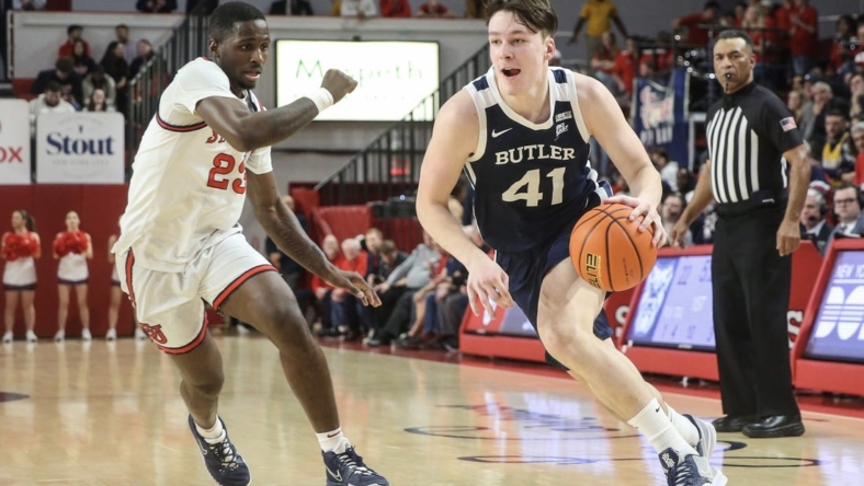 Jan 10, 2023; Queens, New York, USA;  Butler Bulldogs guard Simas Lukosius (41) looks to drive past St. John's Red Storm forward David Jones (23) in the first half at Carnesecca Arena. Mandatory Credit: Wendell Cruz-USA TODAY Sports