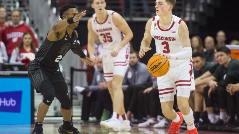 Jan 10, 2023; Madison, Wisconsin, USA;  Wisconsin Badgers guard Connor Essegian (3) dribbles the ball against Michigan State Spartans guard Tyson Walker (2) during the first half at the Kohl Center. Mandatory Credit: Kayla Wolf-USA TODAY Sports