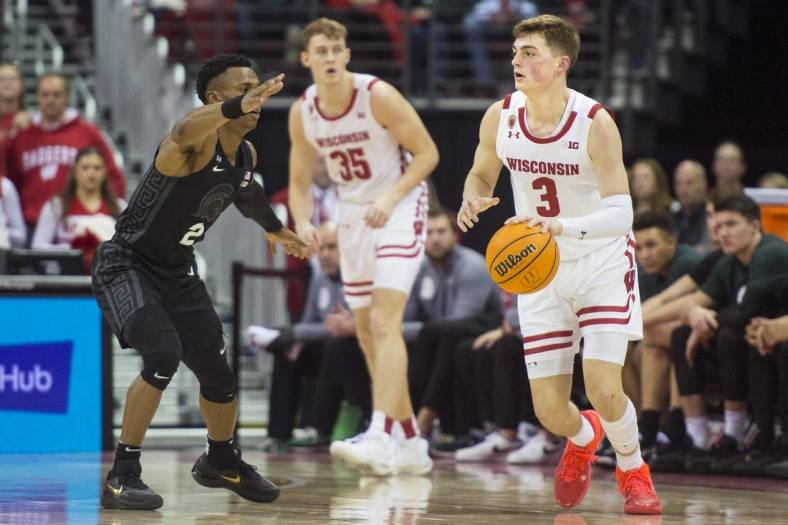 Jan 10, 2023; Madison, Wisconsin, USA;  Wisconsin Badgers guard Connor Essegian (3) dribbles the ball against Michigan State Spartans guard Tyson Walker (2) during the first half at the Kohl Center. Mandatory Credit: Kayla Wolf-USA TODAY Sports