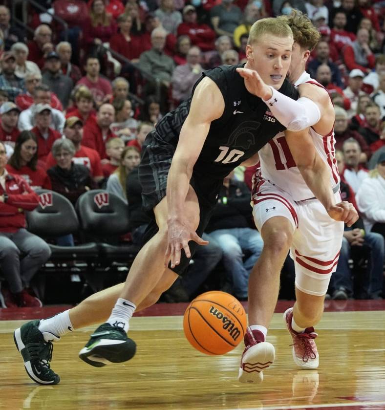Michigan State forward Joey Hauser (10) Dave past Wisconsin guard Max Klesmit (11) during the first half of their game Tuesday, January 10, 2023 at the Kohl Center in Madison, Wis.

Uwmen10 1