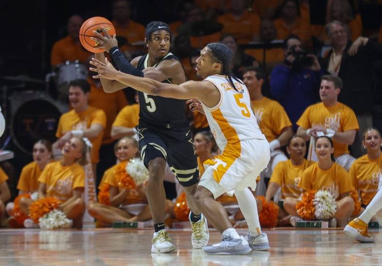 Jan 10, 2023; Knoxville, Tennessee, USA; Vanderbilt Commodores guard Ezra Manjon (5) moves the ball against Tennessee Volunteers guard Zakai Zeigler (5) during the first half at Thompson-Boling Arena. Mandatory Credit: Randy Sartin-USA TODAY Sports