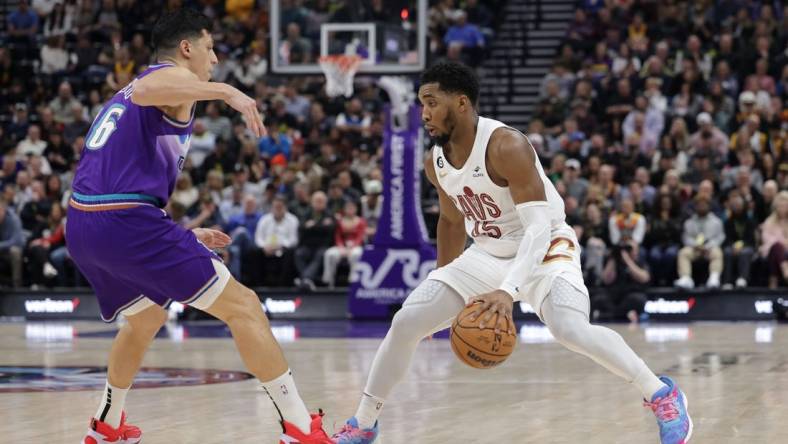 Jan 10, 2023; Salt Lake City, Utah, USA;  Cleveland Cavaliers guard Donovan Mitchell (45) keeps the ball from Utah Jazz forward Simone Fontecchio (16) during the second quarter at Vivint Arena. Mandatory Credit: Chris Nicoll-USA TODAY Sports