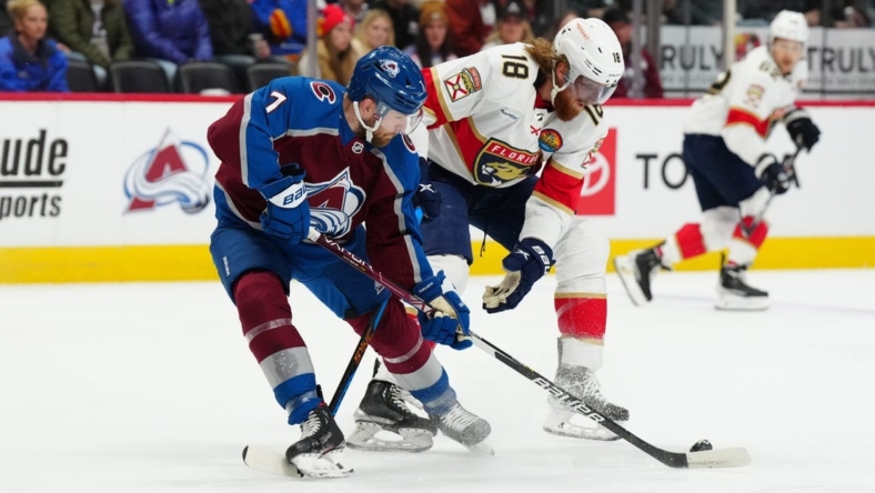 Jan 10, 2023; Denver, Colorado, USA; Florida Panthers defenseman Marc Staal (18) and Colorado Avalanche defenseman Devon Toews (7) battle for the puck in the first period at Ball Arena. Mandatory Credit: Ron Chenoy-USA TODAY Sports
