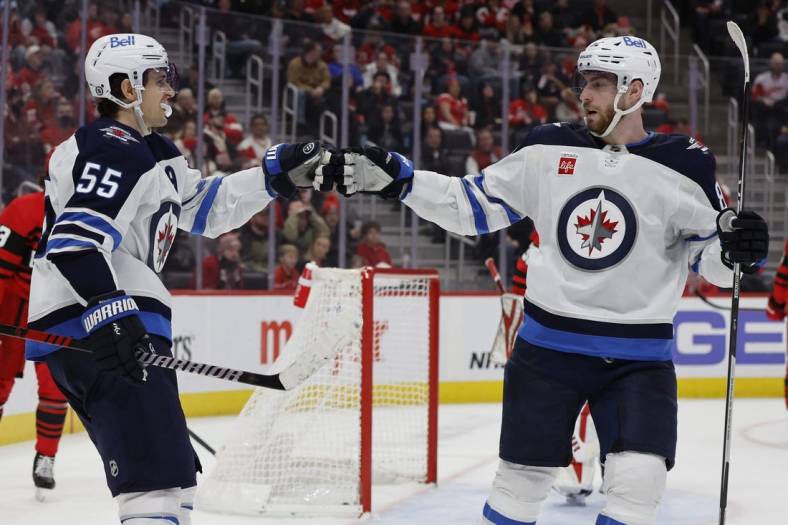 Jan 10, 2023; Detroit, Michigan, USA;  Winnipeg Jets center Mark Scheifele (55) receives congratulations fro left wing Pierre-Luc Dubois (80) after scoring in the third period against the Detroit Red Wings at Little Caesars Arena. Mandatory Credit: Rick Osentoski-USA TODAY Sports