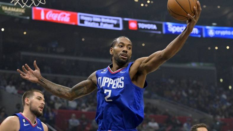 Jan 10, 2023; Los Angeles, California, USA;  Los Angeles Clippers forward Kawhi Leonard (2) reaches for a rebound in the first half against the Dallas Mavericks at Crypto.com Arena. Mandatory Credit: Jayne Kamin-Oncea-USA TODAY Sports