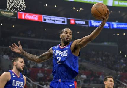 Jan 10, 2023; Los Angeles, California, USA;  Los Angeles Clippers forward Kawhi Leonard (2) reaches for a rebound in the first half against the Dallas Mavericks at Crypto.com Arena. Mandatory Credit: Jayne Kamin-Oncea-USA TODAY Sports