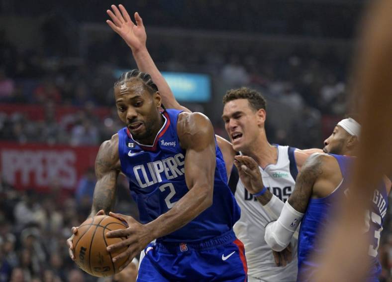 Jan 10, 2023; Los Angeles, California, USA;  Los Angeles Clippers forward Kawhi Leonard (2) reaches in front of Dallas Mavericks center Dwight Powell (7) for a rebound in the first half at Crypto.com Arena. Mandatory Credit: Jayne Kamin-Oncea-USA TODAY Sports