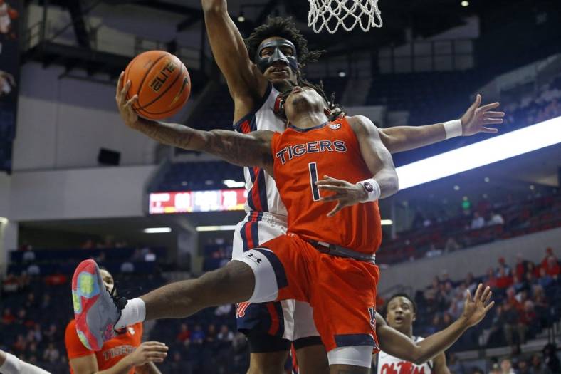 Jan 10, 2023; Oxford, Mississippi, USA; Auburn Tigers guard Wendell Green Jr. (1) drives to the basket as Mississippi Rebels forward Jayveous McKinnis (0) defends during the second half at The Sandy and John Black Pavilion at Ole Miss. Mandatory Credit: Petre Thomas-USA TODAY Sports