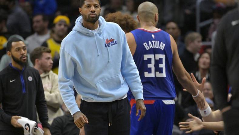 Jan 10, 2023; Los Angeles, California, USA;   Los Angeles Clippers guard Paul George (13) greets players as they come to the bench in the second half against the Dallas Mavericks at Crypto.com Arena. Mandatory Credit: Jayne Kamin-Oncea-USA TODAY Sports