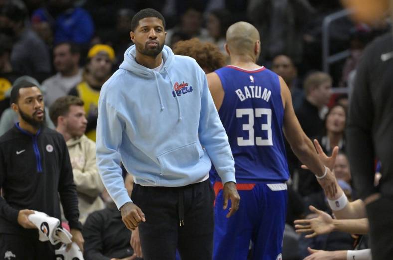 Jan 10, 2023; Los Angeles, California, USA;   Los Angeles Clippers guard Paul George (13) greets players as they come to the bench in the second half against the Dallas Mavericks at Crypto.com Arena. Mandatory Credit: Jayne Kamin-Oncea-USA TODAY Sports
