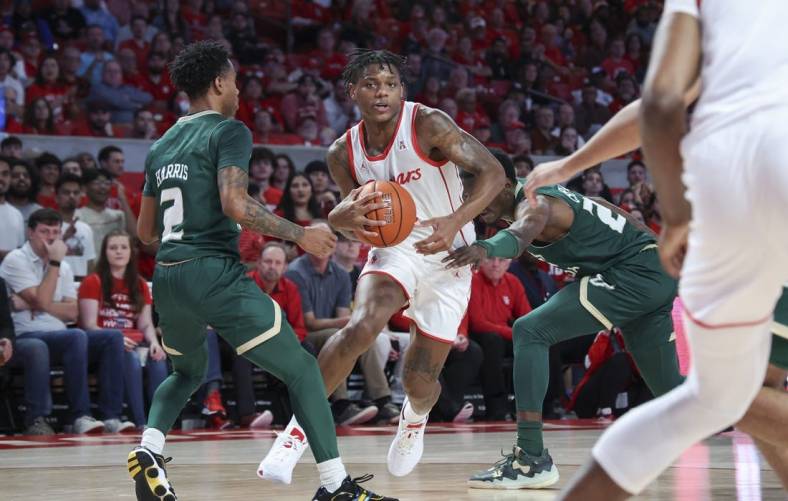 Jan 11, 2023; Houston, Texas, USA; Houston Cougars guard Marcus Sasser (0) drives with the ball as South Florida Bulls guard Tyler Harris (2) defends during the first half at Fertitta Center. Mandatory Credit: Troy Taormina-USA TODAY Sports