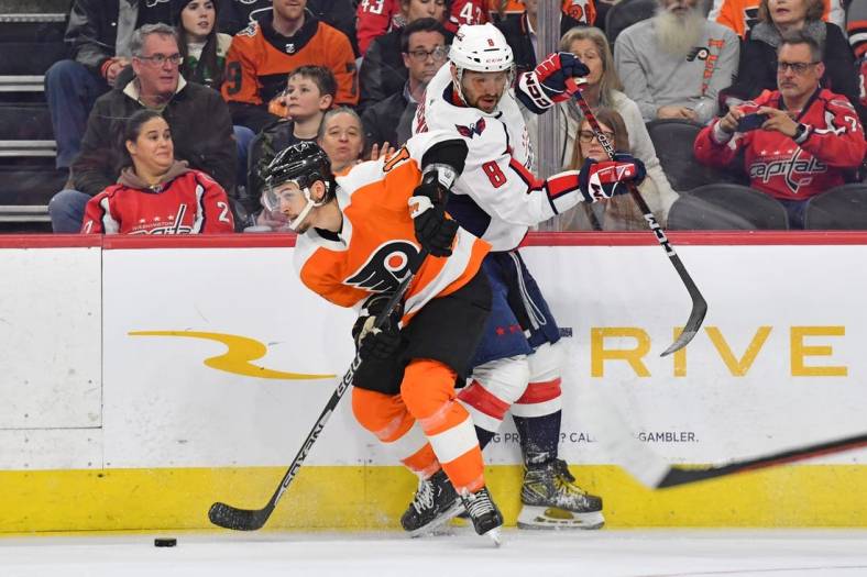 Jan 11, 2023; Philadelphia, Pennsylvania, USA; Philadelphia Flyers right wing Travis Konecny (11) and Washington Capitals left wing Alex Ovechkin (8) battle for the puck during the third period at Wells Fargo Center. Mandatory Credit: Eric Hartline-USA TODAY Sports