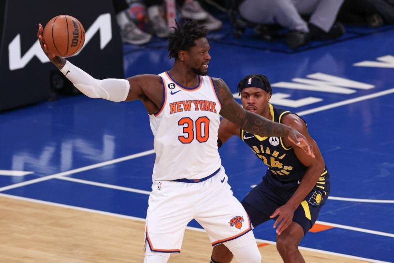 Jan 11, 2023; New York, New York, USA; New York Knicks forward Julius Randle (30) shields the ball from Indiana Pacers guard Buddy Hield (24) during the third quarter at Madison Square Garden. Mandatory Credit: Vincent Carchietta-USA TODAY Sports