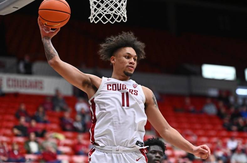 Jan 11, 2023; Pullman, Washington, USA; Washington State Cougars forward DJ Rodman (11) rebounds the ball against the California Golden Bears in the second half at Friel Court at Beasley Coliseum. Mandatory Credit: James Snook-USA TODAY Sports