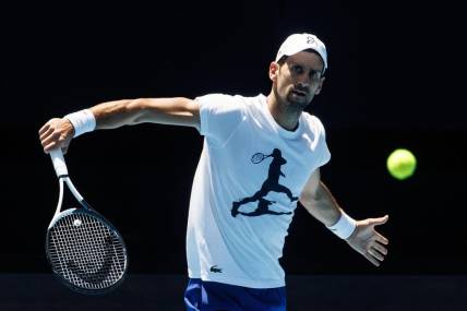Jan 12, 2023; Melbourne, Victoria, Australia; Novak Djokovic of Serbia hits a backhand during a practice session on Rod Laver Arena with his coach Goran Ivanisevic at Melbourne Park. Mandatory Credit: Mike Frey-USA TODAY Sports