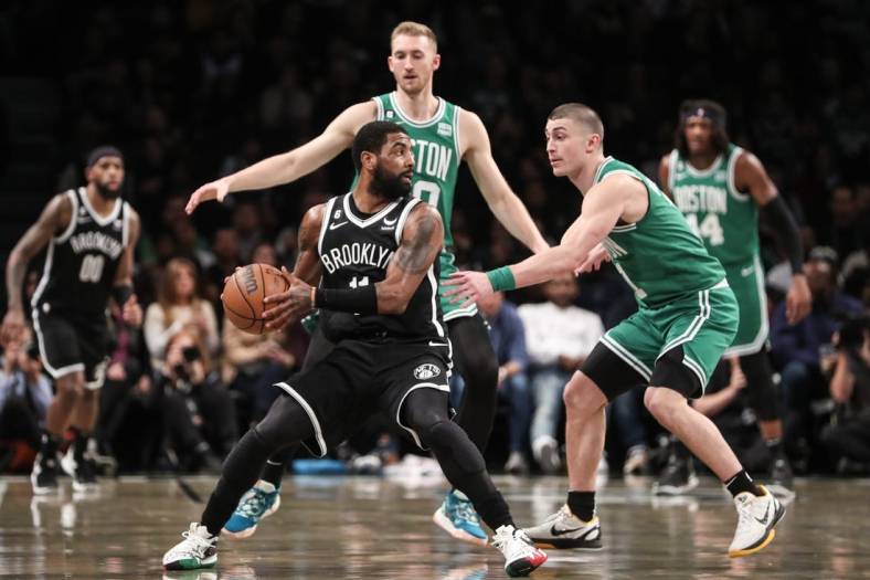 Jan 12, 2023; Brooklyn, New York, USA;  Brooklyn Nets guard Kyrie Irving (11) is guarded by Boston Celtics guard Payton Pritchard (11) in the second quarter at Barclays Center. Mandatory Credit: Wendell Cruz-USA TODAY Sports
