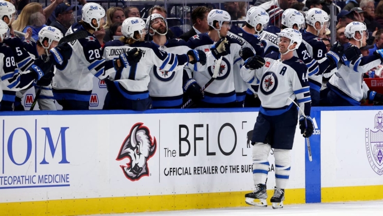 Jan 12, 2023; Buffalo, New York, USA;  Winnipeg Jets defenseman Josh Morrissey (44) celebrates his goal with teammates during the second period against the Buffalo Sabres at KeyBank Center. Mandatory Credit: Timothy T. Ludwig-USA TODAY Sports