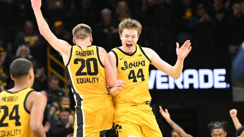 Jan 12, 2023; Iowa City, Iowa, USA; Iowa Hawkeyes forward Riley Mulvey (44) and forward Payton Sandfort (20) react after the game against the Michigan Wolverines at Carver-Hawkeye Arena. Mandatory Credit: Jeffrey Becker-USA TODAY Sports