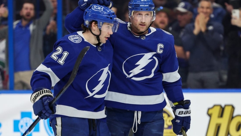 Jan 12, 2023; Tampa, Florida, USA;  Tampa Bay Lightning center Brayden Point (21) congratulates center Steven Stamkos (91) after scoring a goal against the Vancouver Canucks in the third period at Amalie Arena. Mandatory Credit: Nathan Ray Seebeck-USA TODAY Sports