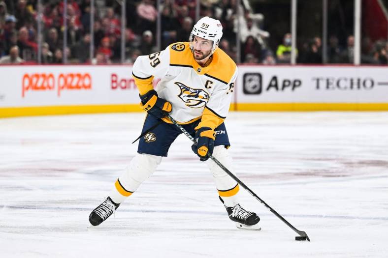 Jan 12, 2023; Montreal, Quebec, CAN; Nashville Predators defenseman Roman Josi (59) plays the puck against the Montreal Canadiens during the third period at Bell Centre. Mandatory Credit: David Kirouac-USA TODAY Sports