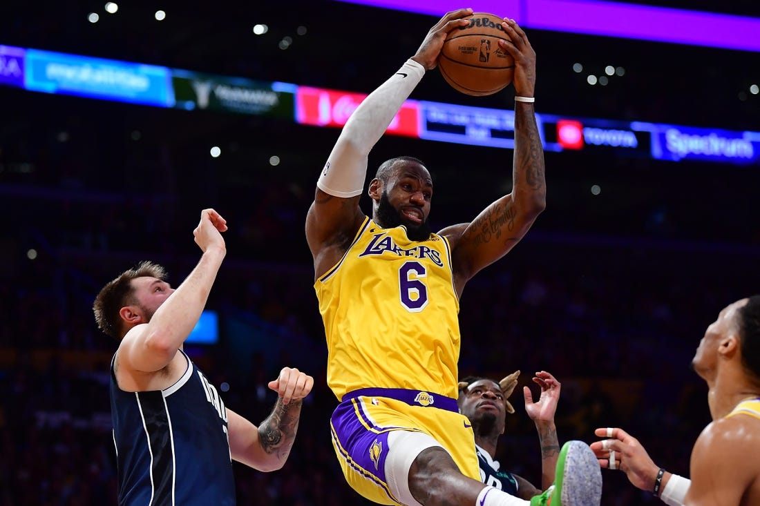 Jan 12, 2023; Los Angeles, California, USA; Los Angeles Lakers forward LeBron James (6) gets the rebound against Dallas Mavericks guard Luka Doncic (77) during the second half at Crypto.com Arena. Mandatory Credit: Gary A. Vasquez-USA TODAY Sports