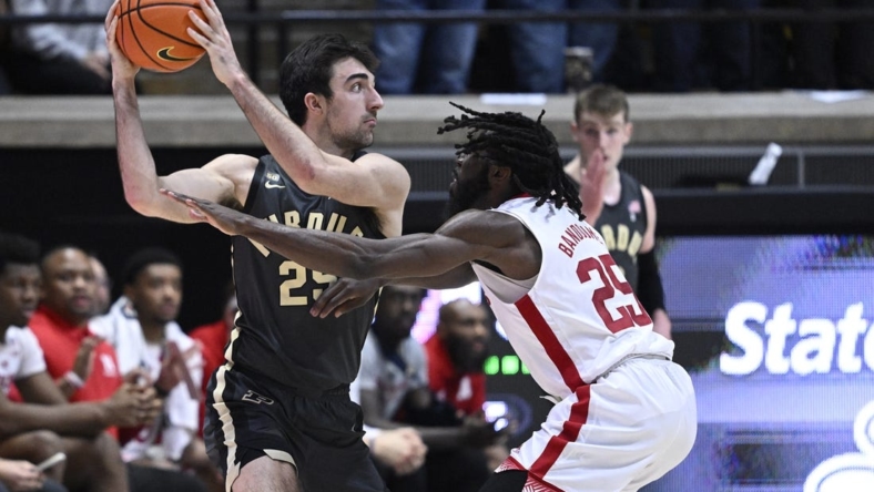Jan 13, 2023; West Lafayette, Indiana, USA;  Nebraska Cornhuskers guard Emmanuel Bandoumel (25) reaches for a ball in the hands of Purdue Boilermakers guard Ethan Morton (25) during the first half at Mackey Arena. Mandatory Credit: Marc Lebryk-USA TODAY Sports
