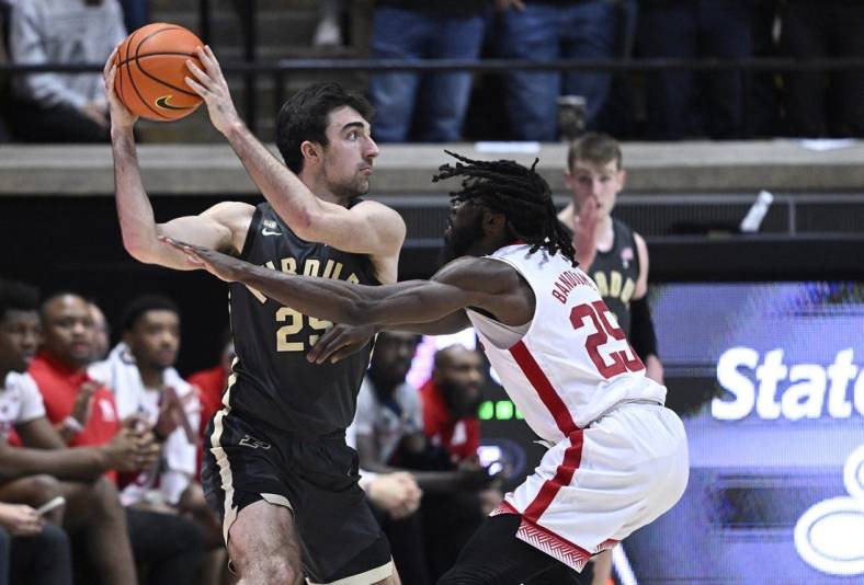 Jan 13, 2023; West Lafayette, Indiana, USA;  Nebraska Cornhuskers guard Emmanuel Bandoumel (25) reaches for a ball in the hands of Purdue Boilermakers guard Ethan Morton (25) during the first half at Mackey Arena. Mandatory Credit: Marc Lebryk-USA TODAY Sports