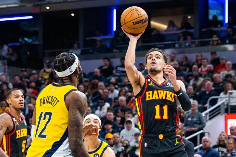 Jan 13, 2023; Indianapolis, Indiana, USA; Atlanta Hawks guard Trae Young (11) shoots the ball while Indiana Pacers forward Oshae Brissett (12) defends in the second quarter at Gainbridge Fieldhouse. Mandatory Credit: Trevor Ruszkowski-USA TODAY Sports