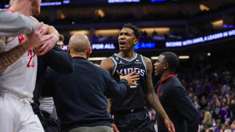Jan 13, 2023; Sacramento, California, USA; Houston Rockets guard Garrison Mathews (25) is confronted by Sacramento Kings guard Malik Monk (0) during the fourth quarter at Golden 1 Center. Both players were ejected from the game. Mandatory Credit: Sergio Estrada-USA TODAY Sports