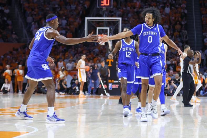 Jan 14, 2023; Knoxville, Tennessee, USA; Kentucky Wildcats forward Oscar Tshiebwe (34) and forward Jacob Toppin (0) react after a play against the Tennessee Volunteers during the first half at Thompson-Boling Arena. Mandatory Credit: Randy Sartin-USA TODAY Sports