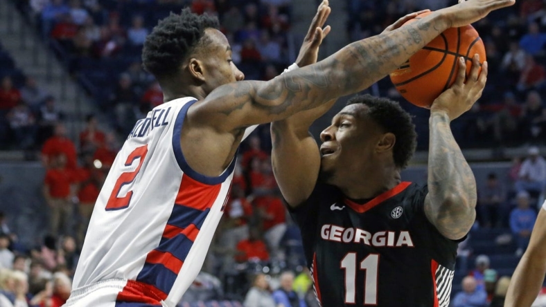 Jan 14, 2023; Oxford, Mississippi, USA; Georgia Bulldogs guard Justin Hill (11) drives to the basket against Mississippi Rebels guard TJ Caldwell (2) during the first half at The Sandy and John Black Pavilion at Ole Miss. Mandatory Credit: Petre Thomas-USA TODAY Sports
