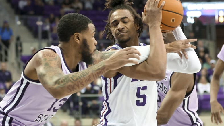 Jan 14, 2023; Fort Worth, Texas, USA;  TCU Horned Frogs forward Chuck O'Bannon Jr. (5) tries to control the ball as Kansas State Wildcats guard Desi Sills (13) and Kansas State Wildcats guard Cam Carter (5) defend during the first half at Ed and Rae Schollmaier Arena. Mandatory Credit: Kevin Jairaj-USA TODAY Sports