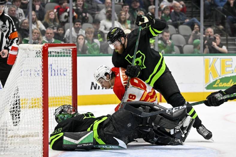 Jan 14, 2023; Dallas, Texas, USA; Dallas Stars goaltender Scott Wedgewood (41) covers up the puck as Calgary Flames left wing Andrew Mangiapane (88) looks for the rebound as defenseman Jani Hakanpaa (2) defends during the first period at the American Airlines Center. Mandatory Credit: Jerome Miron-USA TODAY Sports