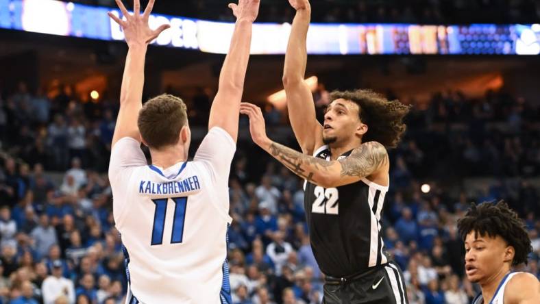 Jan 14, 2023; Omaha, Nebraska, USA;  Providence Friars guard Devin Carter (22) scores over Creighton Bluejays center Ryan Kalkbrenner (11) in the first half at CHI Health Center Omaha. Mandatory Credit: Steven Branscombe-USA TODAY Sports