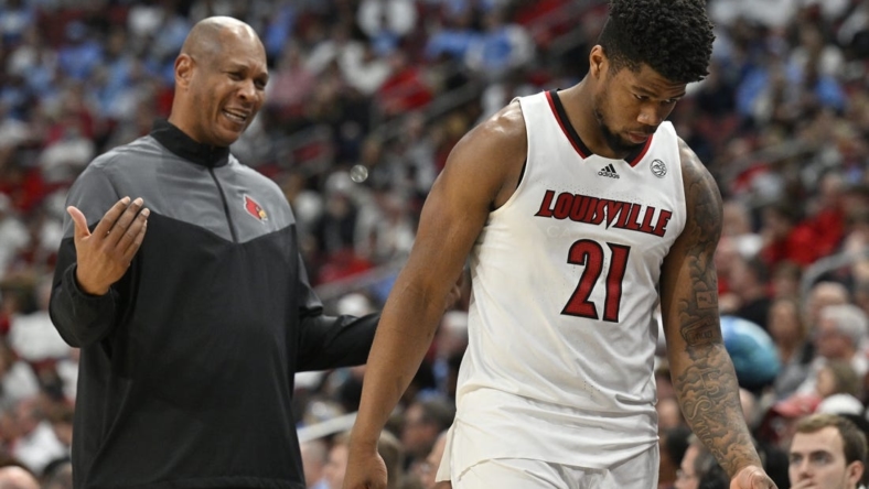 Jan 14, 2023; Louisville, Kentucky, USA;  Louisville Cardinals forward Sydney Curry (21) receives instruction from head coach Kenny Payne as he heads to the bench during the second half against the North Carolina Tar Heels at KFC Yum! Center. North Carolina defeated Louisville 80-59. Mandatory Credit: Jamie Rhodes-USA TODAY Sports