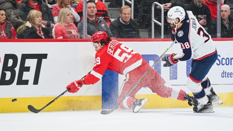 Jan 14, 2023; Detroit, Michigan, USA; Columbus Blue Jackets center Boone Jenner (38) and Detroit Red Wings left wing Tyler Bertuzzi (59) battle for the puck during the first period at Little Caesars Arena. Mandatory Credit: Tim Fuller-USA TODAY Sports