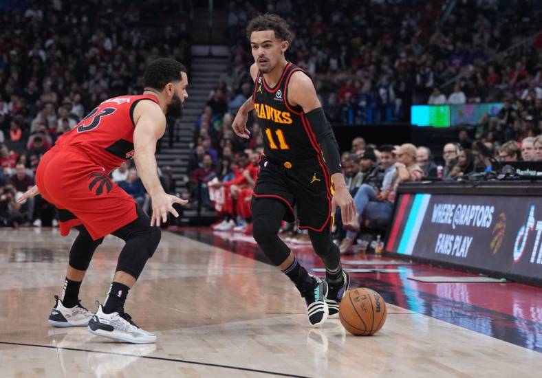 Jan 14, 2023; Toronto, Ontario, CAN; Atlanta Hawks guard Trae Young (11) controls the ball as Toronto Raptors guard Fred VanVleet (23) tries to defend during the first quarter at the Scotiabank Arena against the Toronto Raptors. Mandatory Credit: Nick Turchiaro-USA TODAY Sports