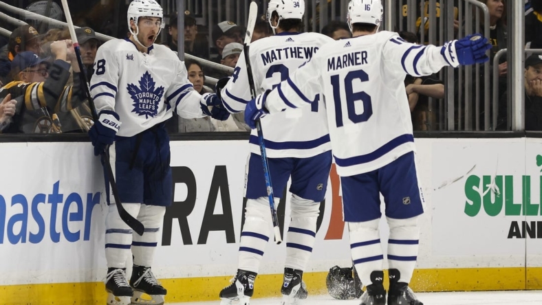 Jan 14, 2023; Boston, Massachusetts, USA; Toronto Maple Leafs left wing Michael Bunting (58) celebrates his goal against the Boston Bruins with right wing Mitchell Marner (16) and Auston Matthews during the first period at TD Garden. Mandatory Credit: Winslow Townson-USA TODAY Sports