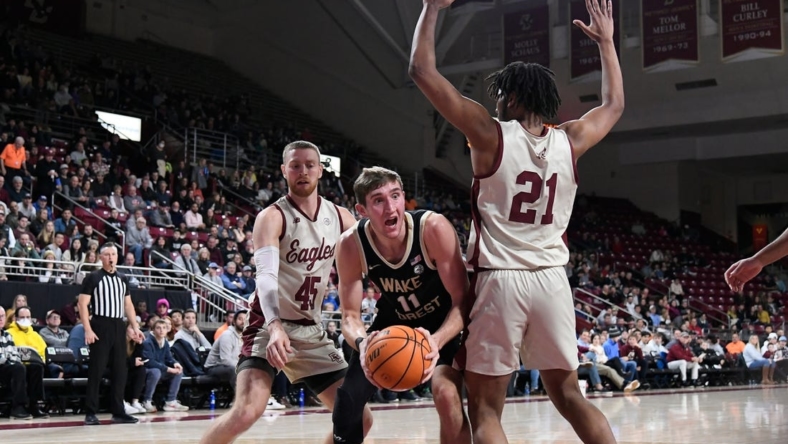 Jan 14, 2023; Chestnut Hill, Massachusetts, USA; Wake Forest Demon Deacons forward Andrew Carr (11) looks for a play around Boston College Eagles forward Devin McGlockton (21)  during the first half at Conte Forum. Mandatory Credit: Eric Canha-USA TODAY Sports
