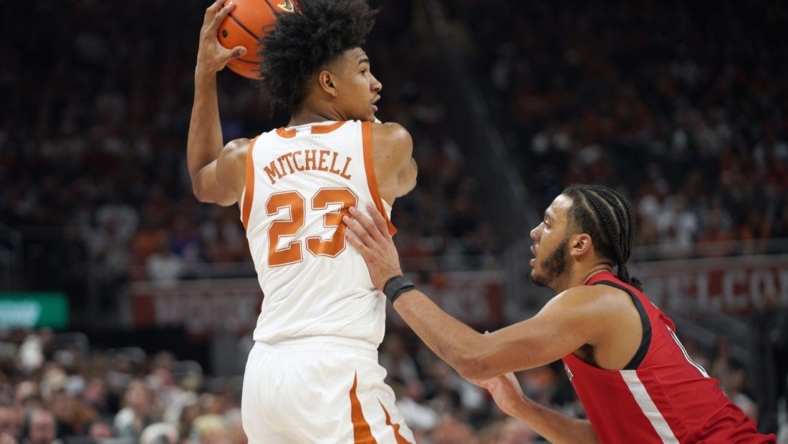 Jan 14, 2023; Austin, Texas, USA; Texas Longhorns forward Dillon Mitchell (23) looks to pass against Texas Tech Red Raiders forward Kevin Obanor (0) during the first half at Moody Center. Mandatory Credit: Dustin Safranek-USA TODAY Sports