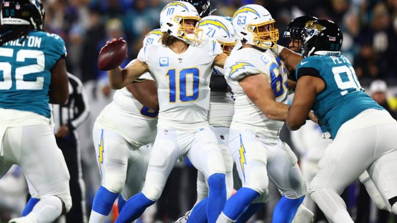 Jan 14, 2023; Jacksonville, Florida, USA; Los Angeles Chargers quarterback Justin Herbert (10) throws during the first quarter of a wild card game against the Jacksonville Jaguars at TIAA Bank Field. Mandatory Credit: Mark J. Rebilas-USA TODAY Sports