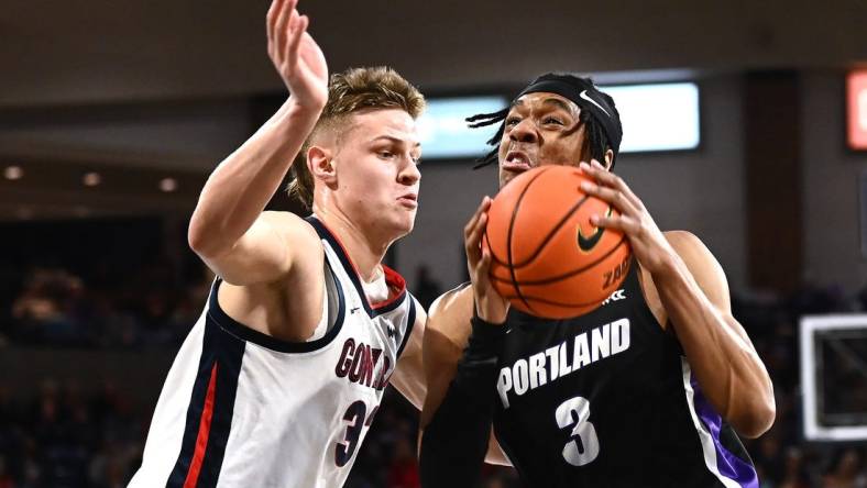 Jan 14, 2023; Spokane, Washington, USA; Portland Pilots forward Alden Applewhite (3) shoots the ball against Gonzaga Bulldogs forward Ben Gregg (33) in the first half at McCarthey Athletic Center. Mandatory Credit: James Snook-USA TODAY Sports